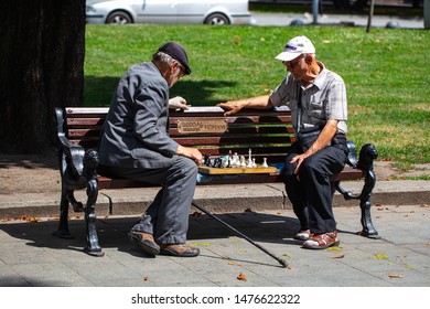 Lviv, Ukraine - July 24, 2019: Two Old Men Playing Chess On Bench In Lviv