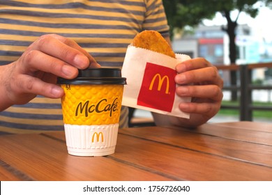 Lviv, Ukraine - June 14, 2020 : Man Having Breakfast Or Lunch With Coffe At McDonald's Restaurant, Sitting At The Wooden Table, Weekday Breakfast Specials