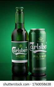 LVIV, UKRAINE - June 16, 2020: Carlsberg pilsner beer in a bottle and tin