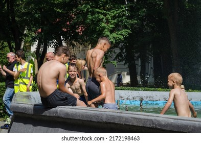 LVIV, UKRAINE - JUNE 26: Children Bathe In The City Park Fountain In Hot Weather In Lviv, Ukraine, June 26, 2022.