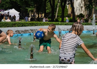 LVIV, UKRAINE - JUNE 26: Children Bathe In The City Park Fountain In Hot Weather In Lviv, Ukraine, June 26, 2022.