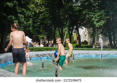 LVIV, UKRAINE - JUNE 26: Children Bathe In The City Park Fountain In Hot Weather In Lviv, Ukraine, June 26, 2022.