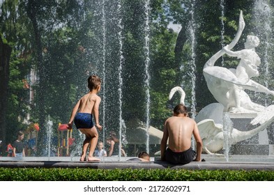 LVIV, UKRAINE - JUNE 26: Children Bathe In The City Park Fountain In Hot Weather In Lviv, Ukraine, June 26, 2022.