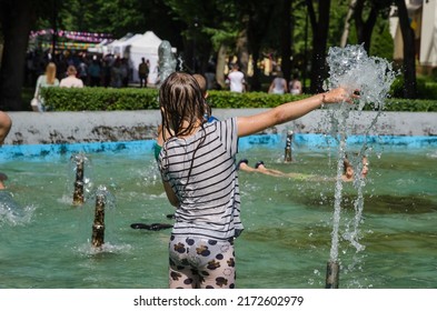 LVIV, UKRAINE - JUNE 26: Children Bathe In The City Park Fountain In Hot Weather In Lviv, Ukraine, June 26, 2022.