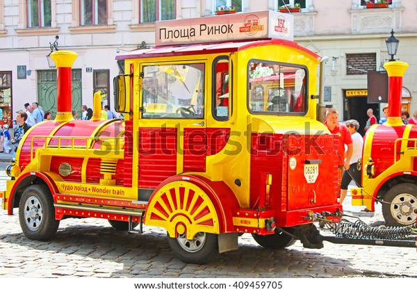 LVIV, UKRAINE - JUNE 29,\
2014: Sightseeing car train  in the center of Lviv, Market square,\
Ukraine