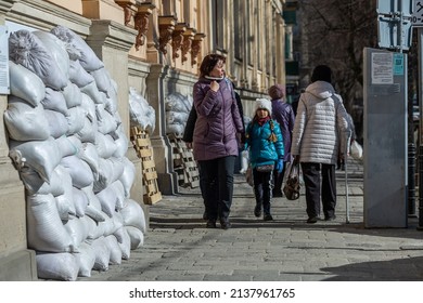 LVIV, UKRAINE - March 20, 2022: In order to protect the facades from damage in the event of bombing, they are covered with sandbags. The central part of Lviv are a UNESCO World Heritage Site.
