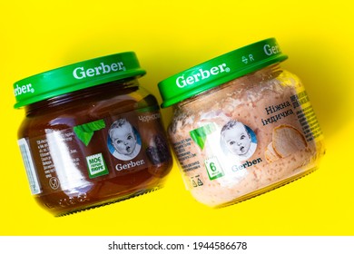 Lviv, Ukraine - March 22, 2020:  Gerber Brand Child Nutrition Puree From Prunes And Turkey On Yellow Background