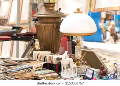 Lviv, Ukraine - May 1, 2022 : Different Antiques On Flea Market Or Traditional Festival - Vintage Lamp, Old Books, Postcards And Other Vintage Things. Collectibles Memorabilia Or Garage Sale Concept