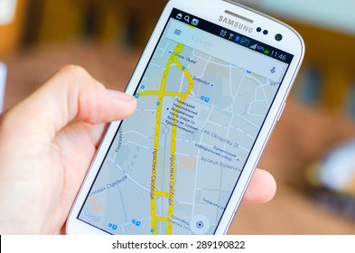 LVIV, UKRAINE - May 19, 2015: Hand Holding White Samsung Smart Phone With Google Map Application