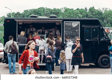 Lviv, Ukraine - May 21, 2017: Group Of People Customers At Mobile Van With Snacks At Street Food Festival. Food Truck With Bbq At Eating Market