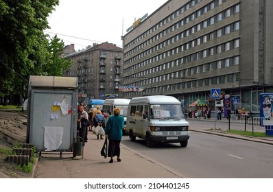 Lviv, Ukraine - May 30 2004: Viacheslava Chornovola Avenue With People Waiting For Local Minibus Transport. Hotel Lviv Before Refurbishment Is Across The Street. Lviv Is Also Known As Lvov.