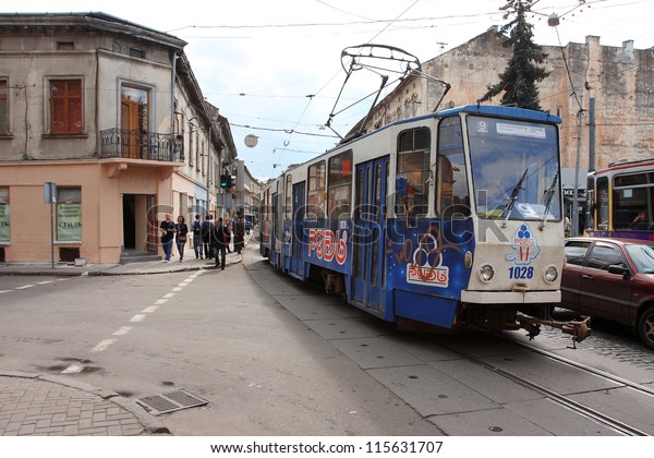 LVIV, UKRAINE - OCT 5: Old streetcar goes along\
the morning streets on October 5, 2012 in Old Town of Lviv,\
Ukraine. Population of Lviv is over 830.000 people. Since 1998 is\
the UNESCO World\
Heritage.