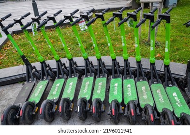 LVIV, UKRAINE - OCTOBER 12, 2021: Row Of City Electric Scooters Parked On The Street For Rent. Eco Transport Concept For Every Day