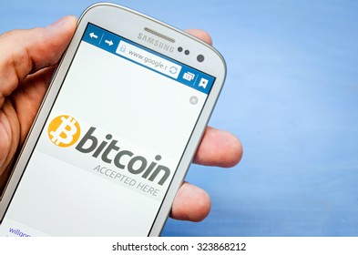 LVIV, UKRAINE - Sept 30, 2015: White Samsung Smart Phone With  Bitcoin Accept Image On Screen,  In Hand