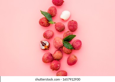 Lychee background. Exotic asian fruits on pink background top-down copy space