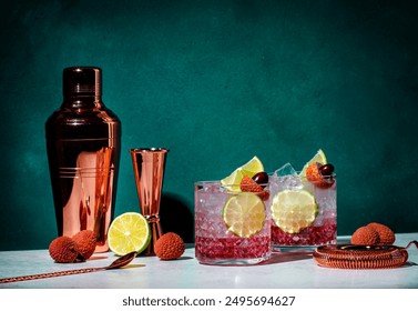 Lychee cocktail drink with vodka, soda, lime juice and ice, dark green background
