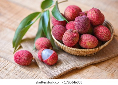 Lychee slice peeled on wooden / Fresh lychee with green leaves harvest in basket from tree tropical fruit summer in Thailand 
