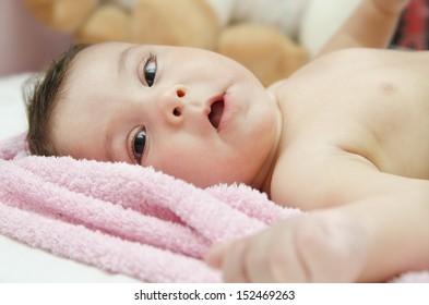 Lying Black Eyed Baby On A Towel.