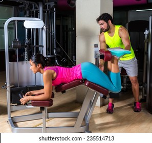 Lying Hamstring Curl Machine Girl With Personal Trainer Man