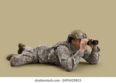 Lying male soldier in uniform looking through binoculars on green background - Powered by Shutterstock