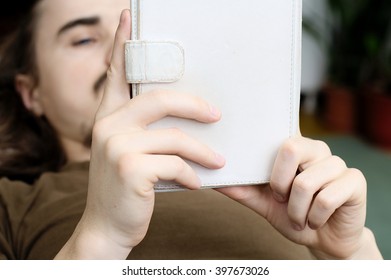 Lying man reading e book reader tablet