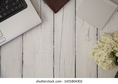 lying on the table laptop notebook touchpad and white flower