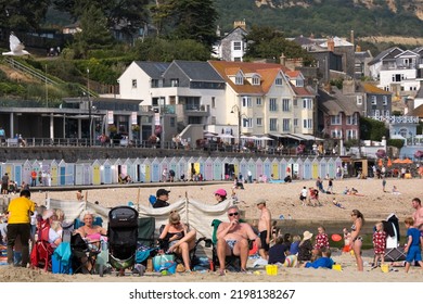 Lyme Regis Dorset England 8.31.22 Holiday Makers Enjoy The Sunshine During The Last Bank Holiday Of The Summer On The Beach At Lyme Regis Dorset UK