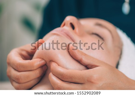 Lymphatic drainage face massage with wooden massager