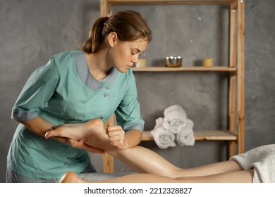 Lymphatic drainage massage of legs and shins. Female feet in the hands of a masseur.Leg massage treatment in the spa salon. A woman receiving a holistic massage treatment. - Powered by Shutterstock