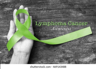 Lymphoma Cancer Awareness, Lime Green Ribbon On Helping Hand (clipping Path)