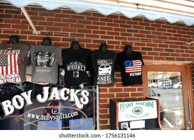 Lynchburg, TN, USA - September 23, 2019:  T-Shirts on sale offering views on kneeling during the national anthem for sale at a Jack Daniels related souvenir shop near the distillery.
