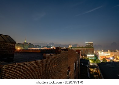 LYNCHBURG, UNITED STATES - Jul 28, 2021: The view in downtown Lynchburg, Virginia at night with a starry sky, brick and art deco buildings in the background