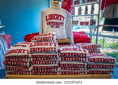 Lynchburg, Virginia - April 22, 2022: Liberty University sweatshirts piled on a table in the college bookstore.