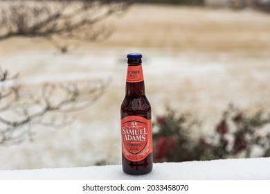 Lynchburg, Virginia  USA - 2122021: A cold bottle of Samuel Adams resting on back deck during the winter.