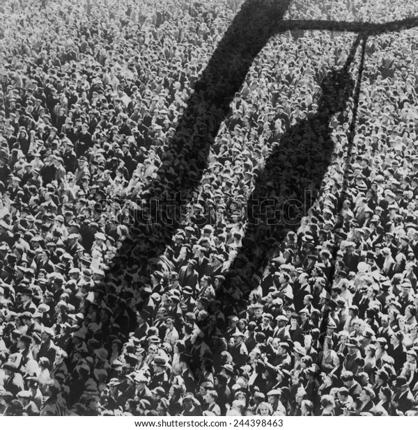 Lynching. The shadow of lynching\
painted over a crowd of white people. In the 1920 and 1930s, the\
NAACP created and distributed lynching-related images. ca.\
1930s