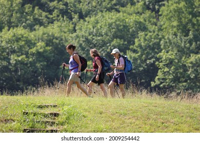 Lyndhurst, Virginia, USA - July 15, 2021: Three Women Hiking At Sherando Lake Recreation Area.