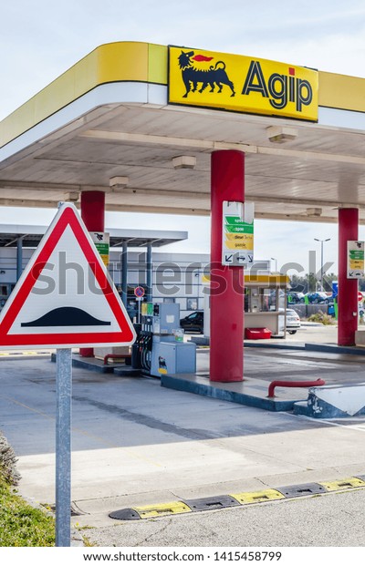 LYON, FRANCE -\
FEBRUARY 26, 2019: Agip, Italian oil and gas company logo on its\
gas service station in Lyon, France on blue sky background. In\
2003, Eni acquired Agip Petroli\
S.p.A