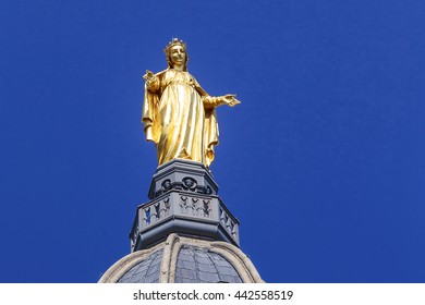 LYON, FRANCE - MAY 24, 2015: Statue of Our Lady decorates the bell tower dome of the Basilica of Notre Dame de Fourviere.