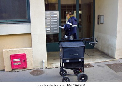 Lyon, France - October 14, 2017: Postman (postwoman, Woman Letter Carrier) With Mail Bag In Form Of Trolley