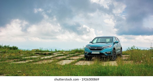 lypovets, ukraine - JUN 22, 2019: suv on the concrete roadside on top of the mountain runa. travel countryside concept. beautiful nature scenery in summer with dramatic sky