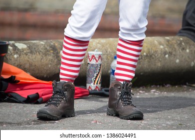 Lytham, Lancashire/UK - April 28th 2019: Legs Dressed In Long Red And White Striped Socks, Long Johns And Walking Boots Isolated 