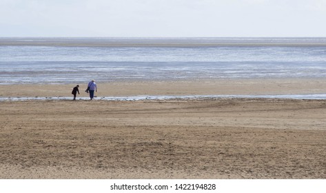 Lytham St Annes, Lancashire/UK - June 3rd 2019: Mother And Son Walking On Wide Sandy Beach With Space For Text Or Copy