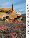 M47 Patton tank displayed with red wire sculptures in a public park, Penha Garcia, Portugal.