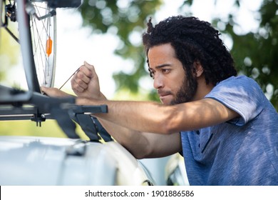 Ma Instals His Mountain Bike On The Car Roof