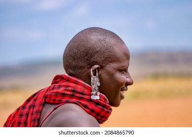 Maasai Mara, Kenya - September 25, 2013. Close-up View Of A Pierced Earring And Traditional Red Fabric Worn By A Male Member Of The Masai Tribe.