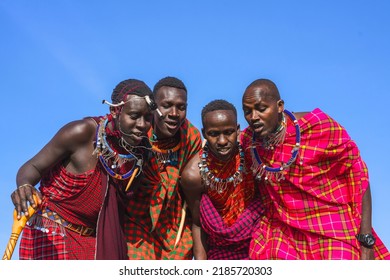 Maasai Mara man in traditional colorful clothing showing traditional Maasai jumping dance at Maasai Mara tribe village famous Safari travel destination near Maasai Mara National Reserve Kenya - Shutterstock ID 2185720303