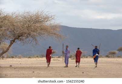 Maasai Warriors In A Landscape Of Tanzanian Savannah