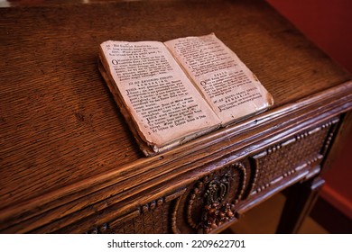 Maastricht, Netherlands - July 01 2022: Holy Book With Historic Spiritual Text And Songs On Wooden Lectern In Church