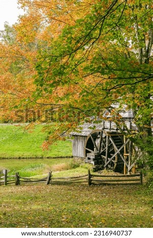 Mabry Mill in National Park in Floyd County Virginia in the fall. Working water mill underneath fall foliage, green, orange, yellow, red leaves. 