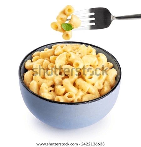 Mac and cheese. Creamy macaroni and cheese pasta isolated on white background. Fork with pasta and basil. With clipping path.